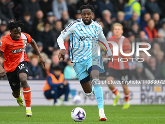 Divock Origi of Nottingham Forest is running with the ball during the Premier League match between Luton Town and Nottingham Forest at Kenil...