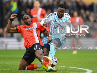 Pelly Ruddock Mpanzu is tackling Divock Origi of Nottingham Forest during the Premier League match between Luton Town and Nottingham Forest...