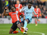 Pelly Ruddock Mpanzu is tackling Divock Origi of Nottingham Forest during the Premier League match between Luton Town and Nottingham Forest...