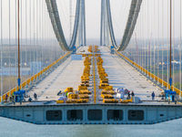 Workers are working at the construction site of the main bridge of the Longtan Yangtze River Bridge in Nanjing, Jiangsu Province, China, on...
