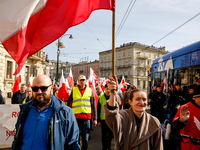 Polish farmers and their supporters walk with Polish flags  and banners during a protest on Lubicz Street in the centre of Krakow, the capit...