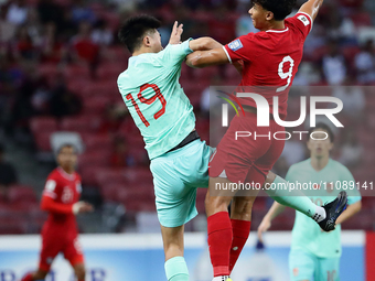 Ikhsan Fandi of Singapore (R) is challenging Liu Yang of China for the ball during the FIFA World Cup Asian 2nd qualifier match between Sing...