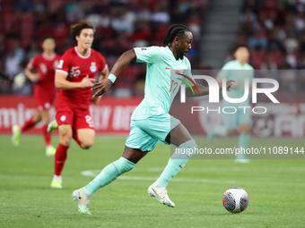 Fernandinho, also known as Fei Nanduo, of China is running with the ball during the FIFA World Cup Asian 2nd qualifier match between Singapo...