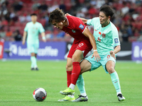 Li Yuanyi of China (R) is challenging Harhys Rizal Stewart of Singapore for the ball during the FIFA World Cup Asian 2nd qualifier match bet...