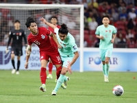 Glenn Kweh of Singapore (L) and Zhang Yuning of China are challenging for the ball during the FIFA World Cup Asian 2nd qualifier match betwe...
