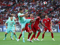 Jiang Guangtai of China (L) is challenging Hariss Harun of Singapore for the ball during the FIFA World Cup Asian 2nd qualifier match betwee...