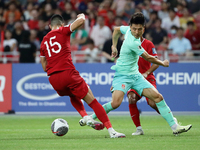 Lionel Tan of Singapore (L) is challenging Wu Lei of China for the ball during the FIFA World Cup Asian 2nd qualifier match between Singapor...
