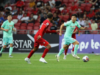 Wu Lei of China (R) is running with the ball during the FIFA World Cup Asian 2nd qualifier match between Singapore and China at the National...