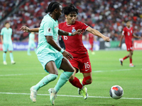 Fernandinho (aka Fei Nanduo) of China (R) and Glenn Kweh of Singapore are challenging for the ball during the FIFA World Cup Asian 2nd quali...