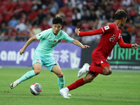 Wu Lei of China (L) is controlling the ball during the FIFA World Cup Asian 2nd qualifier match between Singapore and China at the National...