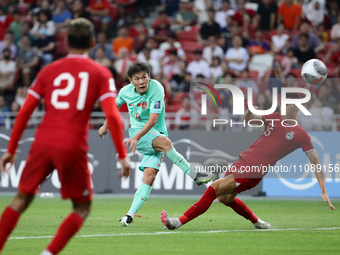 Li Yuanyi of China (C) is shooting at goal during the FIFA World Cup Asian 2nd qualifier match between Singapore and China at the National S...