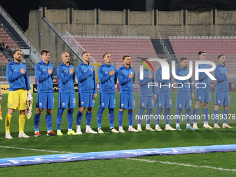 Slovenian national team soccer players are standing and listening to their country's national anthem before the friendly international socce...