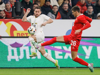 Daniil Khlusevich (R) of Russia and Andrija Zivkovic of Serbia vie for the ball during the international friendly match between Russia and S...