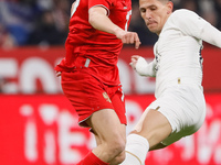 Aleksandr Golovin (L) of Russia and Sasa Lukic of Serbia vie for the ball during the international friendly match between Russia and Serbia...
