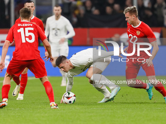 Luka Jovic (C) of Serbia in action against Danil Glebov (L) and Aleksandr Silyanov (R) of Russia during the international friendly match bet...