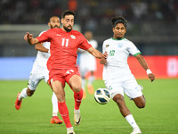 Oday Dabbagh (L) of Palestine is in action against Bishawanath Ghosh of Bangladesh during the FIFA World Cup 2026 and the AFC Asian Cup Saud...