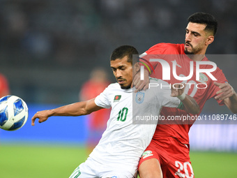 Ameed Mahajneh (R) of Palestine is in action against Rakib Hussain of Bangladesh during the FIFA World Cup 2026 and the AFC Asian Cup Saudi...