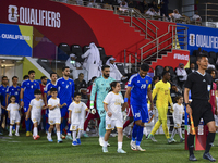 Players from Kuwait and Qatar are walking onto the field before the start of the Qualification Round for the FIFA World Cup 2026 and AFC Asi...