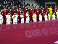The Qatar team players are standing for the national anthem ahead of the Qualification Round for the FIFA World Cup 2026 and AFC Asian Cup 2...