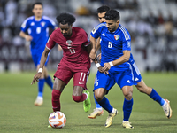 Yusuf Abdurisag (L) of Qatar is battling for the ball with Redha Abujabarah of Kuwait during the Qualification Round for the FIFA World Cup...