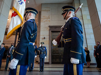 Capitol Police officers salute the American flag as the colors are carried by miltary honor guard to begin a ceremony awarding the Congressi...