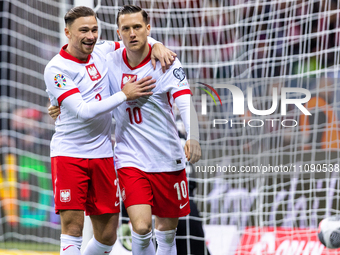 Matty Cash (L) and Piotr Zielinski are celebrating after scoring their second goal for Poland during the UEFA Euro 2024 play-off semi-final...