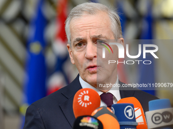 Norway's Prime Minister Jonas Gahr Store is speaking to the press as he arrives to attend the European Council summit on the second day in B...