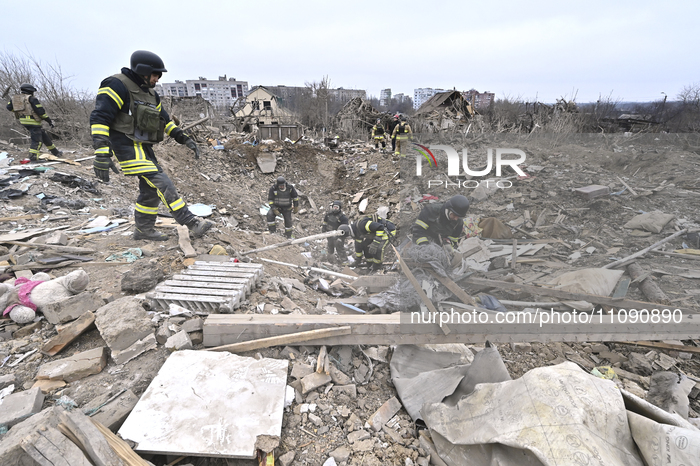 Rescuers are searching among the debris of houses destroyed by a massive missile strike by Russian troops in Zaporizhzhia, Ukraine, on March...