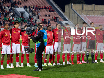 The Malta national soccer team players are standing for their country's national anthem ahead of the friendly international soccer match bet...