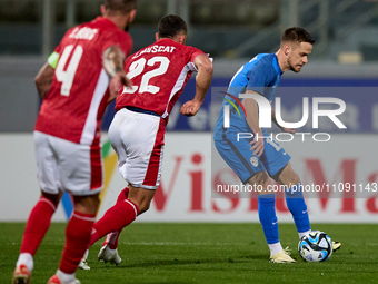 Slovenia national soccer team player Tomi Horvat (R) is in action during the friendly international soccer match between Malta and Slovenia...