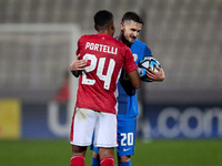 Petar Stojanovic (R) of Slovenia and Neville Portelli (R) of Malta are hugging each other after the friendly international soccer match betw...