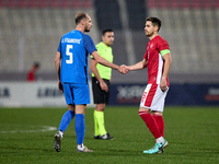 Jon Stankovic (L) of Slovenia is shaking hands with Matthew Guillauimier (R) of Malta after the friendly international soccer match between...