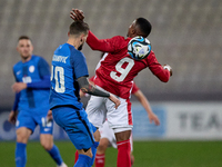 Petar Stojanovic of Slovenia is competing for the ball with Kemar Reid of Malta during the friendly international soccer match between Malta...