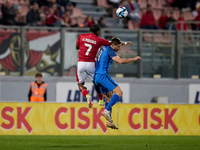 Joseph Mbong (top left) of the Malta national soccer team is competing for the ball with Andraz Sporar (top right) during the friendly inter...