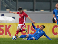 Juan Corbalan of the Malta national soccer team (L) is being closely challenged by Adam Cerin of Slovenia (R) during the friendly internatio...