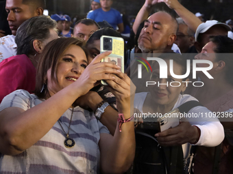 Xochitl Galvez, the presidential candidate for the Fuerza y Corazon por Mexico coalition, is taking a selfie with her supporters during a pr...