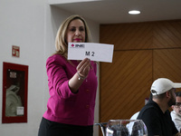 A hostess is showing the role of the electoral raffle during the Public Session of the Table of Representatives of the Presidential Debates,...