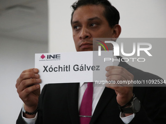 A hostess is showing the name of Xochitl Galvez during the electoral raffle at the Public Session of the Table of Representatives of the Pre...