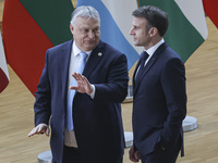 Emmanuel Macron President of France and Viktor Orban Prime Minister of Hungary are talking while they attend a family photo for the 30th ann...