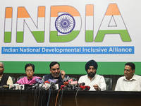 Aam Aadmi Party (AAP) leaders, Atishi Marlena (second from left) and Gopal Rai (center), along with members of INDIA (Indian National Develo...