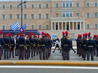 School students are marching through central Athens, past the Hellenic Parliament in Syntagma, dressed in school uniforms and traditional co...
