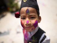 Nepalese people celebrate with each other using colorful powder during the Holi or Fagu Purnima celebration, the festival of colors, in Kirt...
