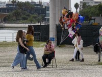 People are walking along one of the walkways in Das Nacoes Park in the Oriente district, in Lisbon, Portugal, on March 13, 2024. (