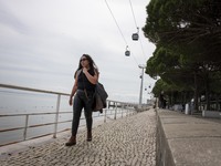 A person is walking near the bank of the Tejo river in the Oriente district in Lisbon, Portugal, on March 13, 2024. (