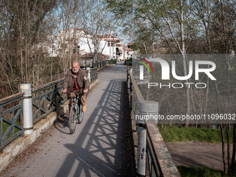 A man is riding his bicycle in Larissa, Greece, on March 24, 2024. Cities that provide space for pedestrians and bicycles are becoming frien...