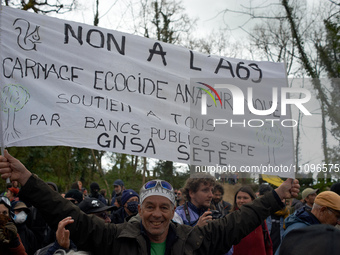 A man is holding a banner that reads 'No to the A69, ecocidal anachronic slaughter'. After spending 37 days in the trees, the last three 'Ec...