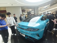 In Hangzhou, China, on March 25, 2024, citizens are looking at the Xiaomi SU7, the first mass-produced car by Xiaomi Motors, at a shopping m...