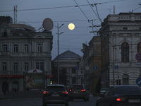 The moon is shining in the sky as the city of Kharkiv, northeastern Ukraine, is experiencing power outages after a Russian missile and drone...