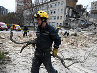 Ukrainian rescuers are working at the site of a building damaged by a Russian rocket attack in Kyiv, Ukraine, on March 25, 2024, amid Russia...