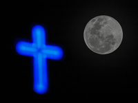 A full worm moon and a Christian cross are being seen in Colombo, Sri Lanka, on March 25, 2024. According to The Old Farmers' Almanac, which...